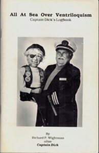 Book cover with the text used in the examples and a picture of a bloke wearing a sailors outfit holding a ventrioquist dummy in his arms.