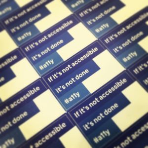 Close-up of a sheet of stickers produced by the Government Digital Service that read "If it's not accessible, it's not done, #a11y"